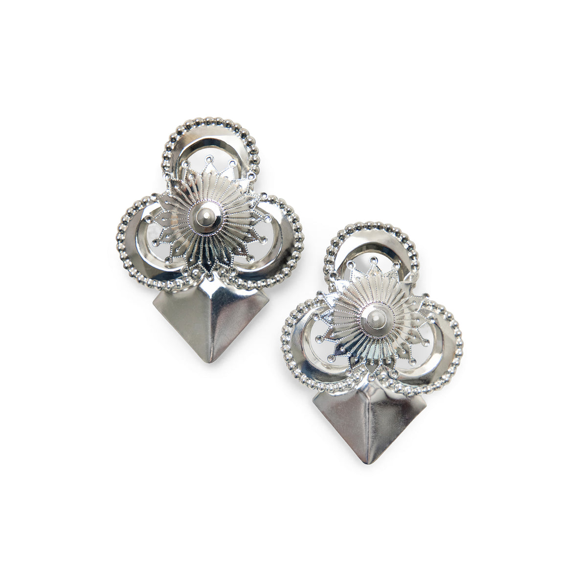 A pair of silver-toned geometric stud earrings with intricate detail, and a pointed triangular base, shown on a plain white background.