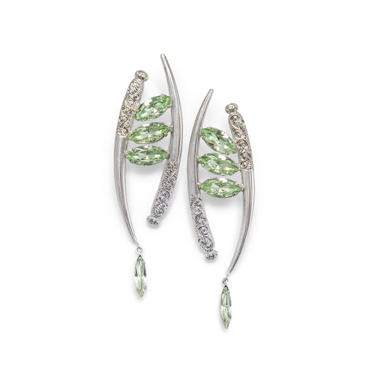 A pair of silver-toned crescent-shaped drop earrings featuring marquise-cut mint green Swarovski crystals and ornate filigree details, set against a plain white background.