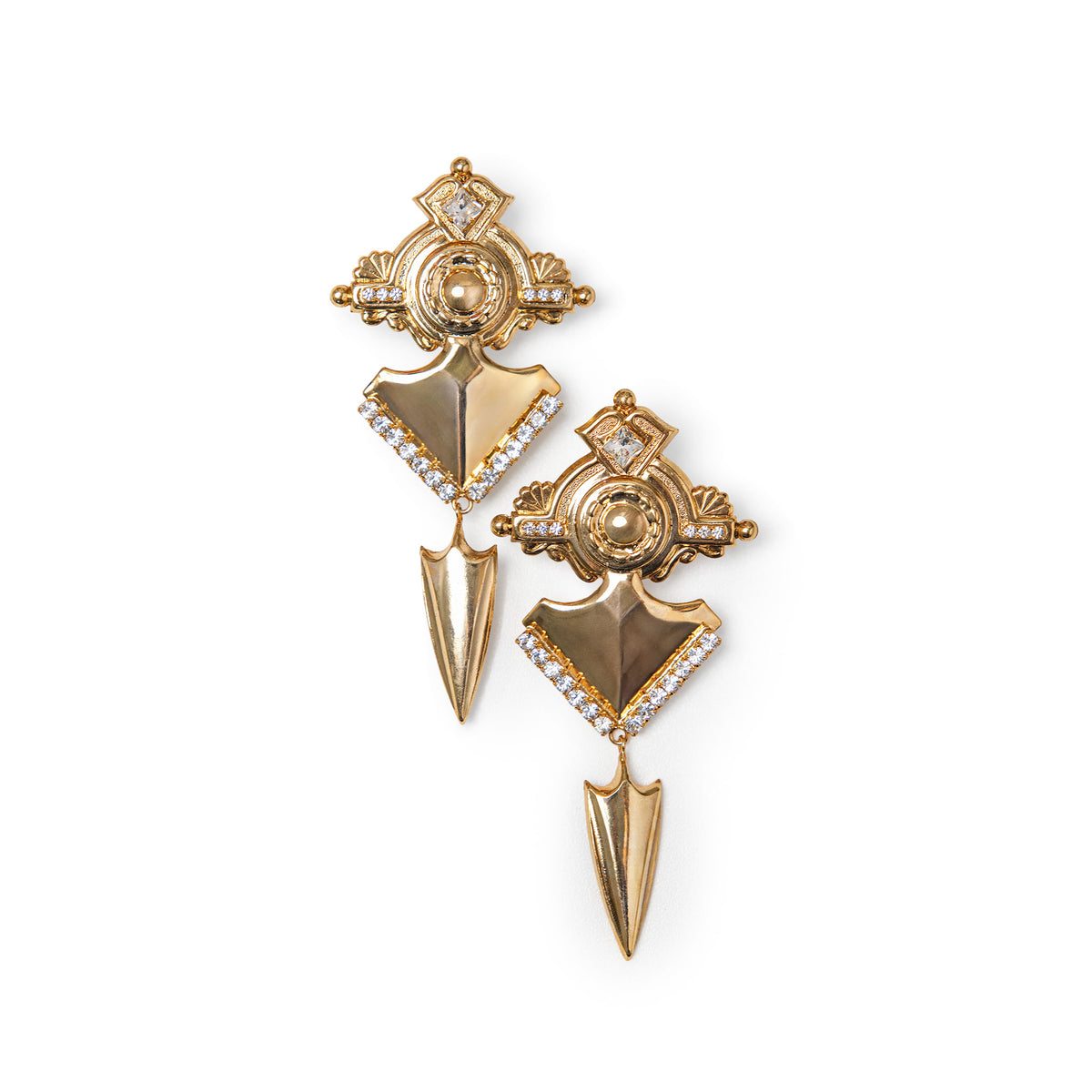 A pair of gold-toned statement earrings with shield and arrowhead motifs, accented by clear crystals, shown on a plain white background.